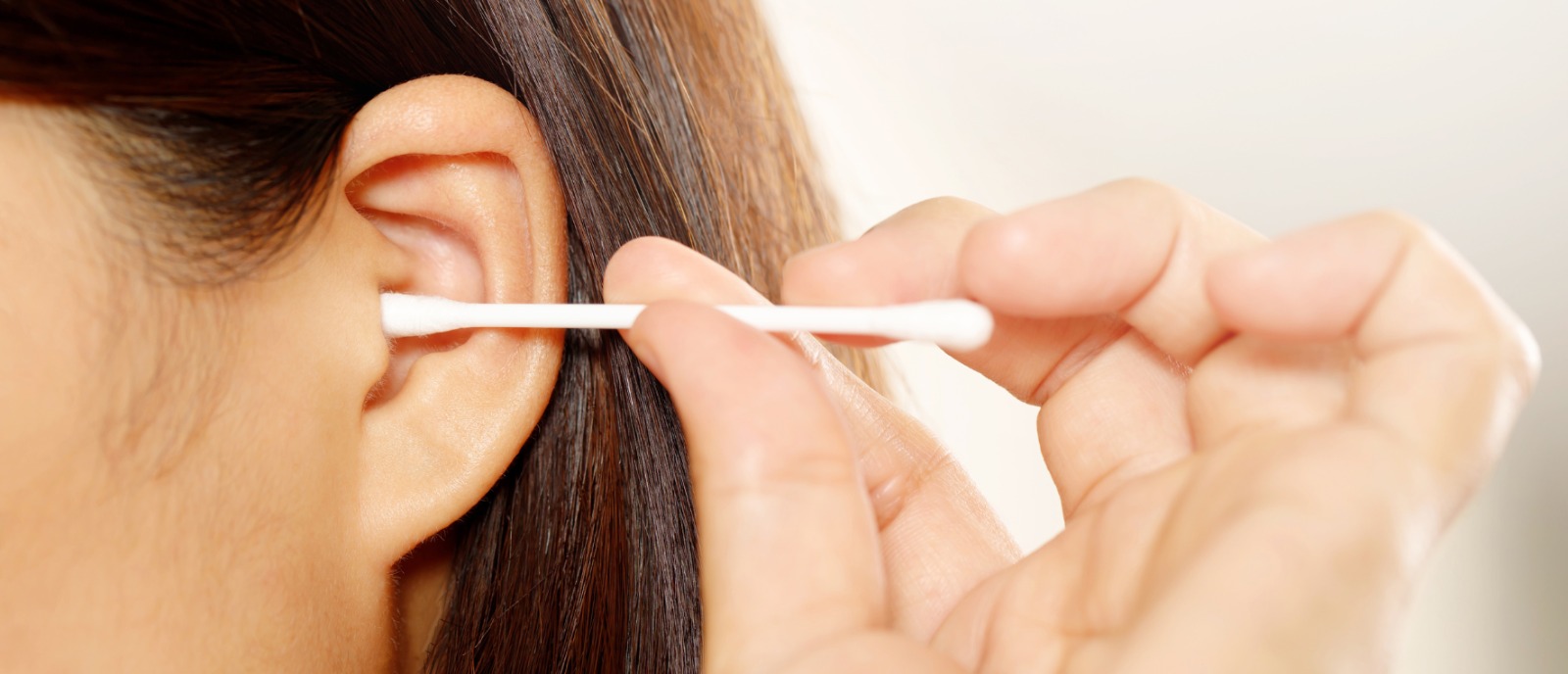 Hearing Loss in Women Over 40: Signs, Ear Wax Causes & Solutions | Aanvii Hearing Middle-aged woman touching her ear, concerned about hearing loss due to ear wax buildup — Aanvii Hearing offers free hearing checkup and advice.